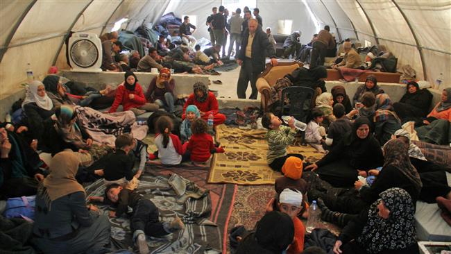Syrians, who were injured in car bombing that targeted buses carrying evacuees from the Kefraya and Foua villages, sit in a tent on the Syrian-Turkish border in Idlib province on April 17, 2017. (Photos by AFP)