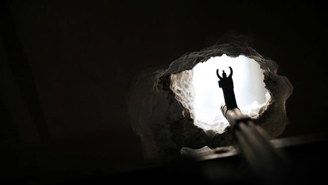 The barrel of a machine gun lies on a hole in the wall of a house used by the Iraqi Federal Police to fight Daesh in western Mosul, Iraq, April 18, 2017.