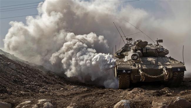 An Israeli Merkava tank drives near the border with Syria in the Israeli-occupied Golan Heights on November 28, 2016.