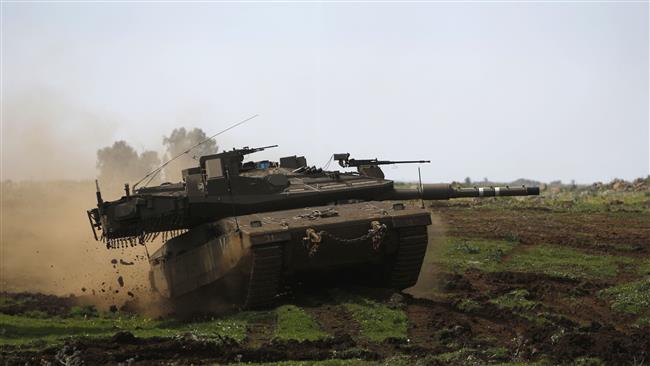 An Israeli tank takes part in a military training in the Golan Heights, near the Israel-Syria border on March 22, 2017. (Photo by AFP)