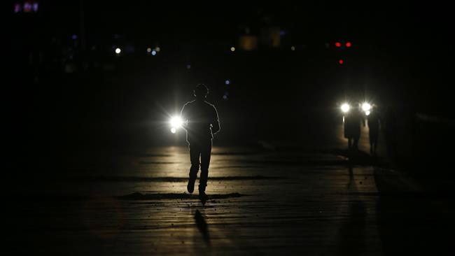 Palestinians walk along a street during a power cut in Gaza City, in the besieged Gaza Strip, Palestine, April 20, 2017. (Photo by AFP)