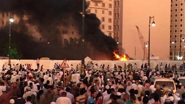 Worshipers watch smoke billowing from a fire after an explosion near the security headquarters of the Prophet’s Mosque in Medina, Saudi Arabia, July 4, 2016. (Photo by Reuters)