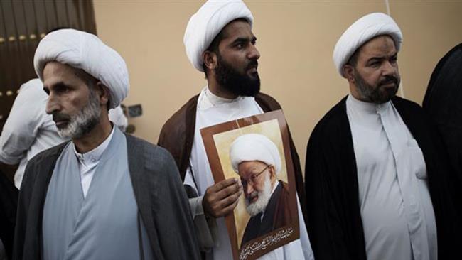 Bahraini Shia clerics attend a protest against the revocation of the citizenship of senior Bahraini Shia cleric Sheikh Isa Qassim (portrait), on June 20, 2016 near his home in the village of Diraz near the capital Manama. (Photo by AFP)