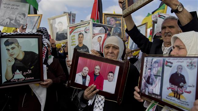Protesters hold pictures of jailed Palestinian prisoners during a rally in support of the hunger-striking inmates in the West Bank city of Ramallah, May 3, 2017. (Photo by AP)