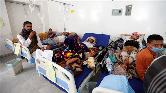 Yemeni men suspected of being infected with cholera receive treatment at a hospital in Sana