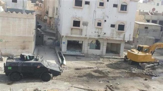 The undated photo, taken by a local resident and shared on Twitter, shows an armored vehicle and a bulldozer standing by to demolish buildings in Awamiyah, eastern Saudi Arabia.