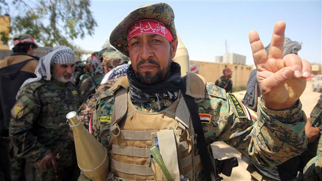Members of the Iraqi pro-government Popular Mobilization Units gesture from the modern town of Hatra southwest of the city of Mosul on April 28, 2017. (Photo by AFP)