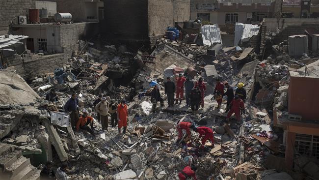 This photo taken on March 24, 2017 shows rescue teams searching through the debris of a building destroyed in a March 17 US airstrike on Mosul, Iraq. (Photo by AP)