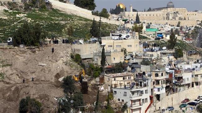In this file photo, an Israeli bulldozer destroys Palestinian houses in the East Jerusalem al-Quds neighborhood of Silwan. (Photo by AFP)