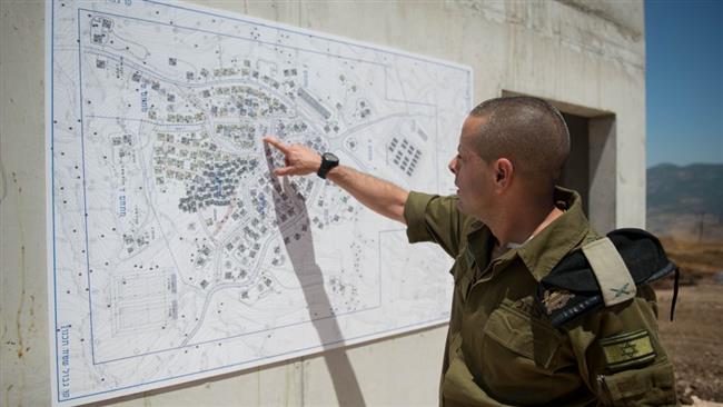Israeli Brigadier General Einav Shalev, the head of the Ground Forces Division, shows the map of a training facility that resembles a Lebanese village, May 29, 2017.