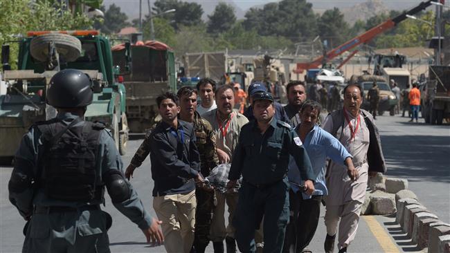 Afghan volunteers carry victims at the site of a car bomb attack in Kabul on May 31, 2017. (Photo by AFP)