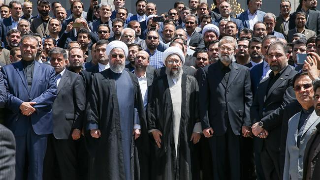 From left to right, Iranian President Hassan Rouhani (4th) stands next to Judiciary Chief Ayatollah Sadeq Larijani and Parliament Speaker Ali Larijani during a funeral held in parliament, June 9, 2017. (Photo by IRNA)