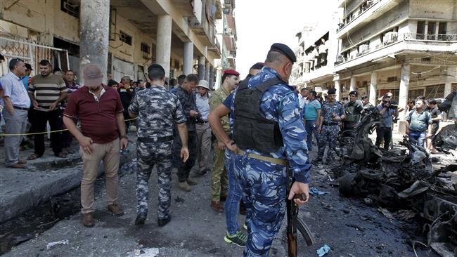 Iraqis gather at the site of a car bomb explosion near Baghdad