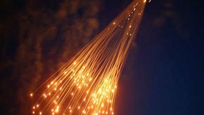 The still shows suspected white phosphorus munitions raining down on Raqqah, Syria, in June 2017.