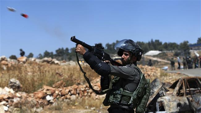 A Israeli border guard fires a tear gas canister during a demonstration by Palestinians and foreigners in the village of Nabi Salih, north of Ramallah, in the Israeli-occupied West Bank on May 26, 2017. (Photo by AFP)