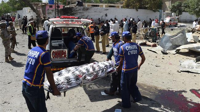 Pakistani medic volunteers transport the body of a victim at the site of an explosion in Quetta, southern Pakistan, June 23, 2017.