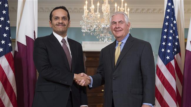 This file photo shows US Secretary of State Rex Tillerson (R) and Qatari Foreign Minister Mohammed bin Abdulrahman al-Thani shaking hands prior to a meeting at the US State Department in Washington, DC, on May 8, 2017. (Photo by AFP)