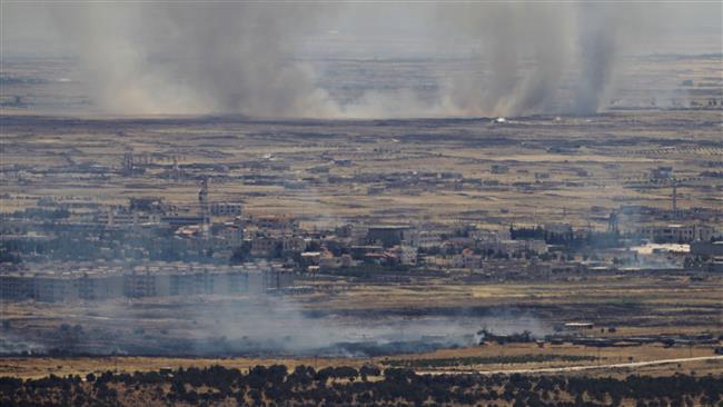 A picture taken from the Israeli-occupied Golan Heights shows smoke billowing from the Syrian side of the border on June 26, 2017. (Photo by AFP)