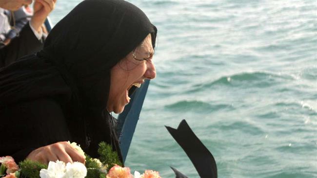 The file picture shows a survivor reacting during a ceremony to commemorate the victims of USS Vincennes’ downing of an Iranian passenger plane on July 3, 1988.