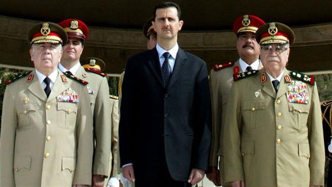 Syrian President Bashar al-Assad (C) (Photo by AFP)