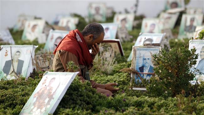 A Yemeni man reacts over the grave of a loved one in a cemetery in the capital Sana’a on June 25, 2017 after the Eid al-Fitr prayer, which marks the end of the holy fasting month of Ramadan. (Photo by AFP)