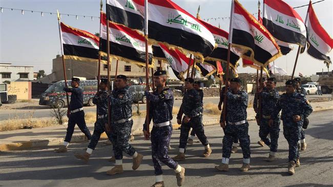 Members of the Iraqi Federal Police parade along a street in Mosul’s Old City on July 2, 2017, where government forces are battling the last remnants of the Daesh Takfiri terrorist group.