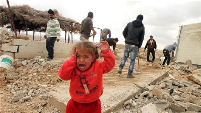 A Palestinian child cries as Palestinians salvage data-x-items from their home after it was demolished by Israeli bulldozers in the area of Musafir Jenbah, south of the occupied West Bank city of al-Khalil (Hebron), on February 2, 2016. (Photo by AFP)