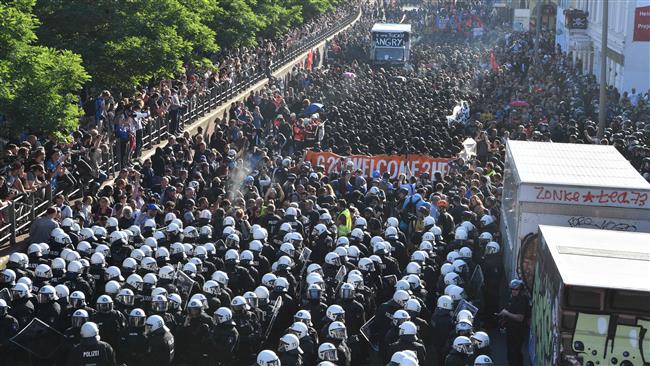 Riot police escort the "Welcome to Hell" rally against the G20 summit in Hamburg, northern Germany on July 6, 2017.