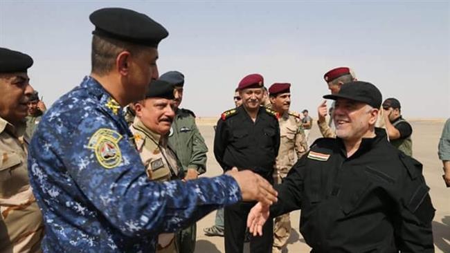Iraqi Prime Minister Haider al-Abadi dressed in a black military uniform and cap greets commanders as he arrives in Mosul on July 9, 2017 to formally announce the recapture of the city from Daesh terrorist group. (Photo via Twitter)