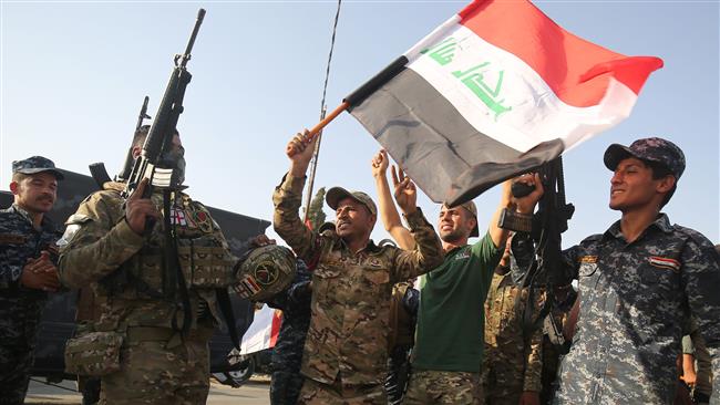 Iraqi federal police members celebrate in the Old City of Mosul on July 9, 2017 after the government