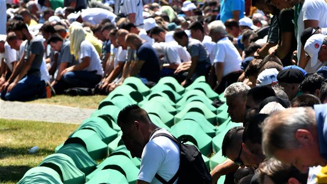 Bosnian Muslims, survivors of the 1995 Srebrenica massacre, as well as other visitors, pray near body caskets of their relatives, laid out at a memorial cemetery in the village of Potocari, near the eastern Bosnian town of Srebrenica, July 11, 2017. (Photo by AFP)