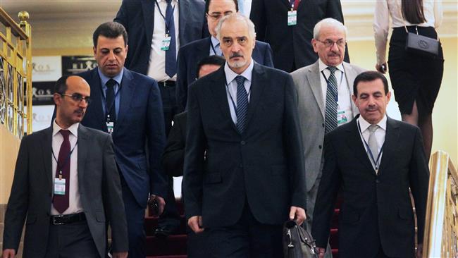 Syrian chief negotiator and envoy to UN Bashar al-Jaafari (C) walks with his delegation during a fifth round of Syria peace talks in Astana on July 5, 2017. (Photo by AFP)