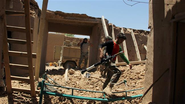 Afghan Border Police personnel walk through an outpost damaged in an airstrike in the Nad Ali district of Helmand Province on June 10, 2017. (Photo by AFP)