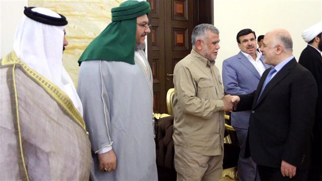 Iraqi Prime Minister Haider al-Abadi (R) shakes hands with Secretary General of Badr Organization Hadi al-Ameri during a meeting with senior commanders of pro-government Popular Mobilization Units (Hashd al-Sha’abi) in Baghdad, Iraq, on July 22, 2017.