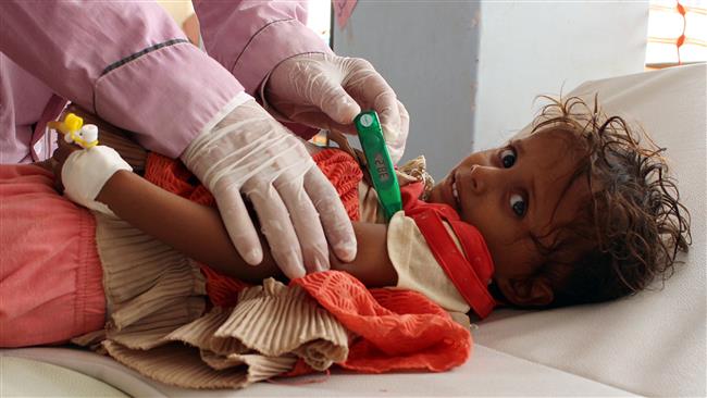 A Yemeni child suspected of being infected with cholera is checked by a doctor at a makeshift hospital operated by Doctors Without Borders (MSF) in the northern district of Abs in Yemen