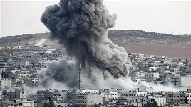 In this file photo, heavy smoke rises from Kobani, Syria, following an airstrike by the US-led coalition there. (Photo by Getty Images)
