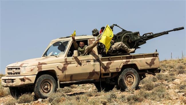 A picture taken on July 26, 2017 shows Hezbollah members manning an anti-aircraft gun mounted on a pick-up truck in a mountainous area around Arsal. (Photo by AFP)