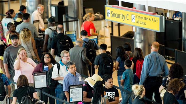 This AFP file photo taken on June 29, 2017 shows travelers waiting in line at the security checkpoint at Baltimore/Washington International Airport in Baltimore, Maryland.