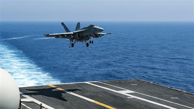 This US Navy handout photo obtained July 1, 2017 shows an F/A-18E Super Hornet, attached to the "Golden Warriors" of Strike Fighter Squadron (VFA) 87,as it prepares to land aboard the aircraft carrier USS George H.W. Bush (CVN 77)in the Mediterranean Sea on June 25, 2017. (Photo by AFP)