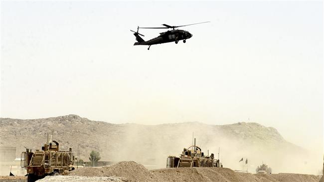 A US military helicopter flies over the site of a bomb attack that targeted a NATO convoy in Kandahar, south of Kabul, Afghanistan, August 2, 2017. (Photo by AP)
