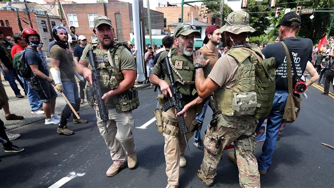White nationalists, neo-Nazis and members of the "alt-right" with body armor and combat weapons evacuate comrades who were pepper sprayed after the "Unite the Right" rally was declared a unlawful gathering by Virginia State Police August 12, 2017 in Charlottesville, Virginia. (Photo by AFP)