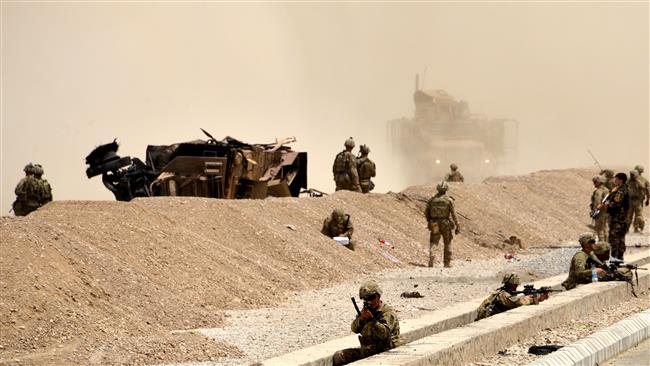 US soldiers keep watch near the wreckage of their vehicle at the site of an attack by Taliban in Kandahar, Afghanistan, August 2, 2017. (Photo by AFP)