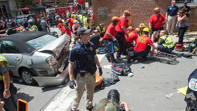 A woman receives first-aid after a car ran into a crowd of protesters in Charlottesville, Virginia, on August 12, 2017. (Photo by AFP)