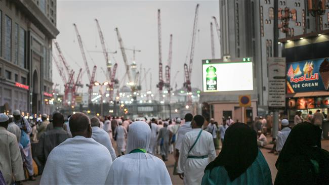 Muslim pilgrims walk towards the Grand Mosque in the holy city of Mecca on September 13, 2015.