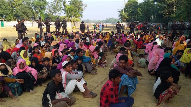 This file photo taken on December 25, 2016 shows Rohingya Muslims from Myanmar who tried to cross the Naf river into Bangladesh to escape sectarian violence being kept under watch by Bangladeshi security officials in Teknaf. (AFP photo)