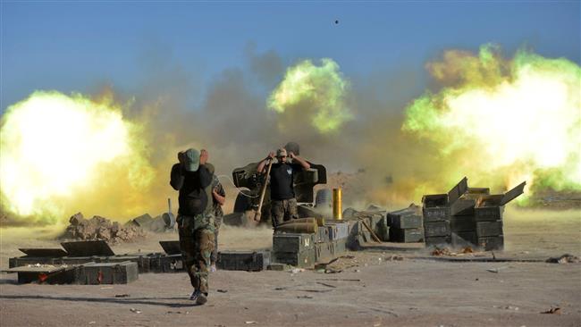 Fighters from Popular Mobilization Units fire against the Daesh Takfiri militants on the outskirts of Tal Afar, Iraq, on August 20, 2017. (Photo by Reuters)