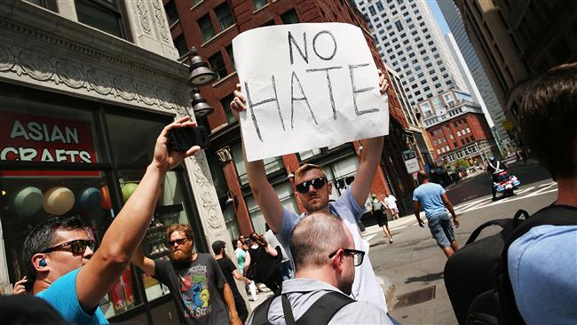 A protester holds a sign following a march in Boston, August 19, 2017. (Photo by AFP)