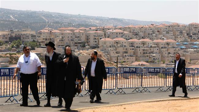 Israelis walk at the site of a corner stone ceremony in the Beitar Illit settlement south of East Jerusalem al-Quds on August 3, 2017. (Photo by AFP)