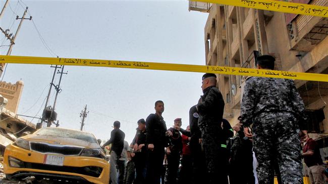 Iraqis gather at the site of a car bomb explosion near Baghdad