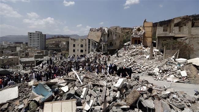 Yemenis stand amid the debris of a house, which was hit by a Saudi-led airstrike on a residential district, in the capital, Sana’a, August 26, 2017. (Photo by AFP)